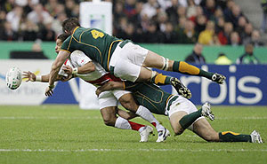AP Photo/Mark Baker  — Jason Robinson is tackled during the Rugby World Cup 2007 final