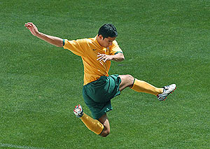 Socceroo Tim Cahill leaps - AAP Image/Dave Hunt