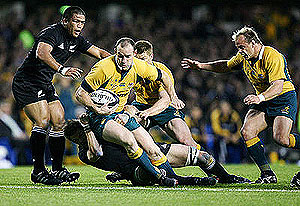 Australian Wallaby Stirling Mortlock is tackled by New Zealand All Blacks Richie McCaw. AP Photo/NZPA, Wayne Drought.