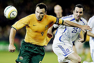 Australian captain Mark Viduka (9) competes for the ball with Sotirios Kyrgiakos of Greece. AP Photo/Mark Baker