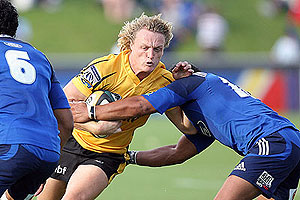 Western Force's Ryan Cross is tackled by Blues' Isaia Toeava - AAP Image/NZPA, Wayne Drought