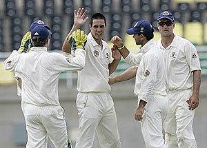 Australia's pacer Mitchell Johnson, center, is congratulated by teammates after taking the wicket of Jamaica Select XI's batsman Nikita Miller, unseen, during the first day of a cricket tour match in Trelawny, northern Jamaica, Friday, May 16, 2008. AP Photo/Andres Leighton