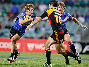 Western Force’s James O’Connor tries to shrug a tackle by the Chiefs Stephen Donald - AAP Image/Tony McDonough