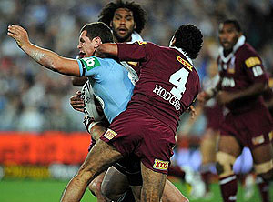 N.S.W Blues Benn Cross is tackled by Queenslands Sam Thaiday and Justin Hodges during game 1 of the State of Origin at ANZ Stadium, Sydney, Wednesday, May 21, 2008. N.S.W defeated Queensland 18 - 10. AAP Image/Dean Lewins