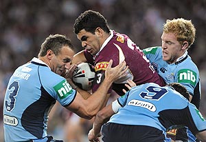 Queensland's Greg inglis is tackled by Mark Gasnier and Peter Wallis during the NRL State of Origin match between Queensland and New South Wales at Suncorp Stadium. AAP Image/Dave Hunt