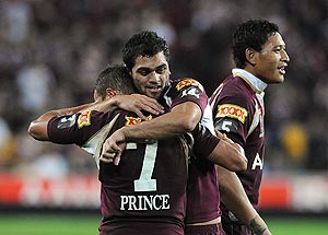 Queenslanders Scott Prince (left) and Karmichael Hunt (centre) embrace after the final whistle of the NRL State of Origin match between Queensland and New South Wales at Suncorp Stadium in Brisbane, Wednesday, June 11, 2008. AAP Image/Dave Hunt