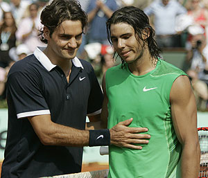 Spain's Rafael Nadal receives a pat on the stomach from Switzerland's Roger Federer - AP Photo/Christophe Ena