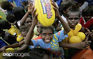 Aboriginal children participate in a coaching clinic with players from the Western Bulldogs during the Western Buldogs community camp in Oenpelli, February 3, 2005 in Darwin, Australia. GSP Images
