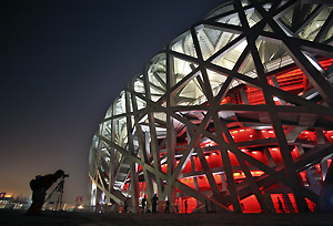 In this May 25, 2008 file photo, a photographer focuses on the National Stadium, also known as the Bird\'s Nes in Beijing. The stadium will host the opening and closing ceremonies and athletics competition at the Olympic Games, which open Aug. 8. AP Photo/Robert F. Bukaty