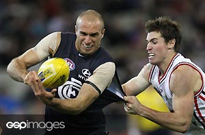 Chris Judd of Carlton is tackled by Lenny Hayes of St Kilda during the AFL Round 15 match between the Carlton Blues and the St Kilda Saints at the MCG. GSP images