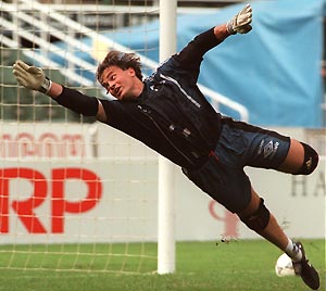 Manchester United goalkeeper Mark Bosnich attempts to stop the ball during a training session held at the Hong Kong Stadium on Friday, July 23, 1999. AP Photo/Anat Givon