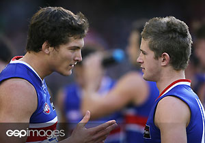 Will Minson (L) talks to first amer Callan Ward at the 1/4 time break during the AFL Round 11 match between the St Kilda Saints and the Western Bulldogs at the Telstra Dome. GSP Images