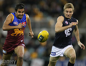 Anthony Corrie of Brisbane and Dennis Armfield of Carlton in a race for the ball during the AFL Round 21 match between the Brisbane Lions and the Carlton Blues at the Gabba. Photo Slattery