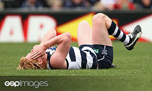 Cameron Ling of Geelong lays on the ground after a collision with Dean Soloman of Fremantle