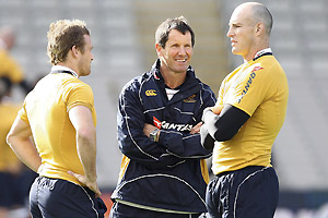 Australian Wallabies Coach Robbie Deans, center, talks to players Matt Giteau, left, and Stirling Mortlock during the captain's run at Eden Park in Auckland, New Zealand, Friday, Aug. 1, 2008. Australia will play against New Zealand on Saturday. AP Photo/NZPA, Wayne Drought