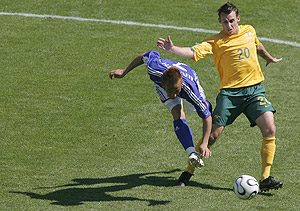 Australia's Luke Wilkshire, right, looks on as Japan's Hidetoshi Nakata fires a shot during their World Cup Group F soccer match in Kaiserslautern, Germany, Monday, June 12, 2006. Other teams in Group F are Brazil and Croatia. AP Photo/Ivan Sekretarev