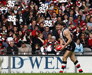 The St Kilda supporters hold up in tribute the No 35 as St Kilda's Robert Harvey prepares to kick - Photo by Slattery Images