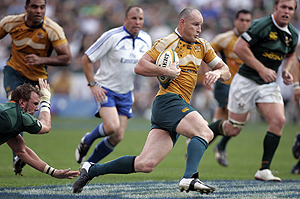 Australia\'s captain Stirling Mortlock, second from right, on his way to score a try during the Tri-Nations rugby match against South Africa at the ABSA stadium in Durban, South Africa, Saturday Aug. 23, 2008. Australia beat South Africa 27-15. AP Photo/Themba Hadebe