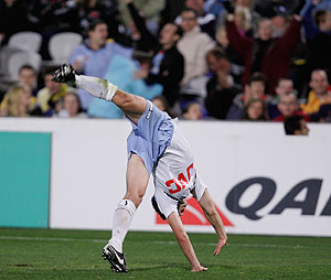 Shannon Cole of Sydney celebrates scoring his teams third goal with a cart wheel during the round two, A-League match between the Gold Coast Mariners and Sydney FC at Blue Tongue Stadium in Gosford on Saturday, Aug. 23, 2008. Sydney beat the Mariners 3-2. (AAP Image/Sergio Dionisio) 