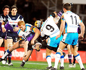 Dallas Johnson from the Storm is spear tackled in the NRL, round 25, Gold Coast Titans vs Melbourne Storm, Olympic Park, VIC, Sunday Sept 2, 2007. AAP Image/Action Photographics/Jeff Crow