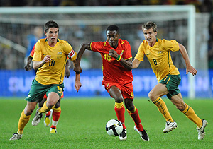 Australia's Harry Kewell takes control of the ball from Ghana's Eric Addo as Kewell's team mate Joel Griffiths offers support during their friendly match at the Sydney Football Stadium, Sydney, Friday, May 23, 2008. AAP Image/Dean Lewins