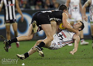 Collingwood\'s Nathan Brown tackles St Kilda\'s Stephen Milne during the AFL Round 19 match between the Collingwood Magpies and the St Kilda Saints at the MCG. GSP Images