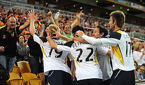 Central Coast Mariners Goal scorer Matt Simon (left) reacts with spectators after scoring in the first half of Round 3, A-League match between the Central Coast Mariners and the Queensland Roar at Suncorp Stadium in Brisbane, Aug. 31st, 2008. The Mariners beat the Roar 4-2. AAP Image/Dave Hunt