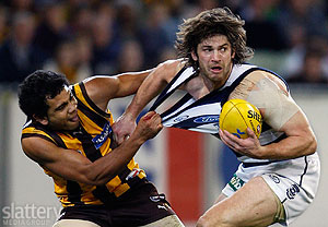 Hawthorn\'s Cyril Rioli tackles Geelong\'s Max Rooke in their Round 17 match at the MCG. (Image courtesy of GSP Images)