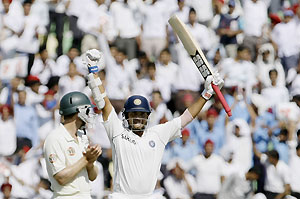  Indian batsman Sourav Ganguly, right, reacts after scoring a century as Australian player Simon Katich applauds on the second day of the second cricket test match between India and Australia, in Mohali, India, Saturday, Oct. 18, 2008. AP Photo/Gautam Singh