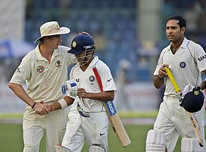 India's Gautam Gambhir, center, is congratulated by Australian Brett Lee as Indian V.V.S. Laxman, right, looks on as they return after end of play on the first day of their third cricket test match in New Delhi, India, Wednesday, Oct. 29, 2008. Gambhir scored his second hundred in consecutive matches with an unbeaten 149 Wednesday. AP Photo/Gurinder Osan