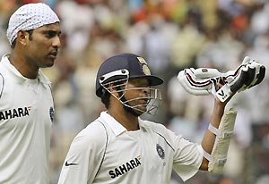 Indian batsmen Sachin Tendulkar, right, and V.V.S Laxman return for the tea interval on the final day of the first cricket test match between India and Australia, in Bangalore, India, Monday, Oct. 13, 2008. AP Photo/Gautam Singh