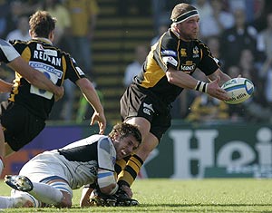 Wasps Phil Vickery, right, is tackled by Castres Olympique' Lei Tomiki, bottom left, during their European Cup rugby union pool 1 match at Adams Park, in High Wycombe, England, Sunday, Oct. 12, 2008. AP Photo/Alastair Gran