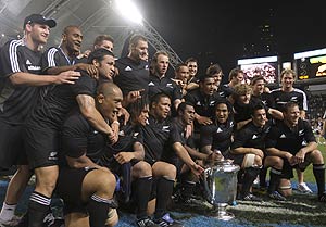 New Zealand's All Blacks players pose with the trophy after defeating Australia Wallabies to win the Bledisloe Cup in Hong Kong Saturday, Nov. 1, 2008. All Blacks won 19-14. AP Photo/Vincent Yu