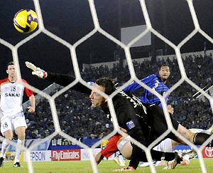 Brazilian forward Lucas of Japan's Gamba Osaka, top right, keeps eyes on the ball after executing a goal against Australia's Adelaide United goalkeeper Eugene Galekovic in the first half of the first leg of the Asian Champions League final in Osaka, western Japan, Wednesday, Nov. 5, 2008. Lucas scored a goal and set up another as Gamba defeated Adelaide 3-0. AP Photo/Kyodo News