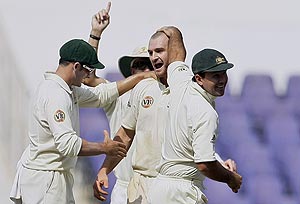 Australian bowler Jason Krejza, center, is congratulated by teammates Ricky Ponting, right, and Mike Hussey for dismissing Indian batsman Ishant Sharma, unseen, on the second day of the fourth and final cricket test match between India and Australia in Nagpur, India, Friday, Nov. 7, 2008. AP Photo/Gautam Singh