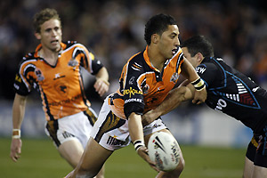 Tigers Benji Marshall (centre) gets a pass away during the NRL Rugby League, Round 16, Penrith Panthers V Wests Tigers game in Sydney, Saturday, June 24, 2006. AAP Image/Action Photographics/Jonathan Ng