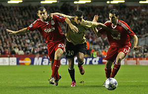 Marseille's Hatem Ben Arfa, centre, attempts to force his way between Liverpool's Javier Mascherano, left, and Alvaro Arbeloa during their Champions League, Group D, soccer match at Anfield Stadium, Liverpool, England, Wednesday, Nov. 26, 2008. AP Photo/Paul Thomas