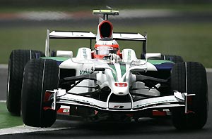 Brazil's Rubens Barrichello steers his Honda during the free practice session ahead of Sunday's Formula One Grand Prix in Monza, Italy, in this Sept. 12, 2008 file photo. Honda's Chief Executive Takeo Fukui announced Friday Dec. 5, 2008 that Honda has pulled out of Formula One, citing a slowdown in the global economy and a need to focus on its core business activities. AP Photo/Antonio Calanni