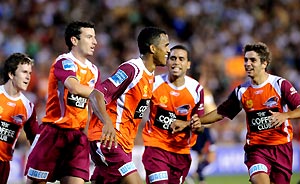 The Queensland Roar celebrate a penalty goal scored by Reinaldo (centre) against the Newcastle Jets during the preliminary final in Newcastle, Sunday, Feb. 17, 2008. AAP Image/Paul Miller)