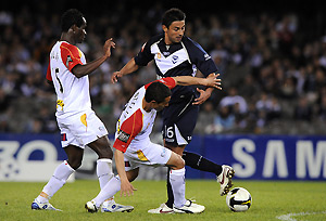Melbourne Victory foward Carlos Hernandez is challenged by Adelaide United midfielder Jonas Salley and Lucas Pantelis, during their A-League round 4 match, at the Telstra Dome in Melbourne, Friday, Sept. 12, 2008. AAP Image/Joe Castro