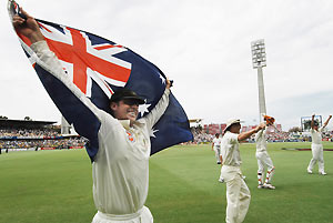 Dec. 18, 2006 file photo of Australia's Matthew Hayden holding up the Australian flag as he celebrates with his team mates after Australia regained the Ashes on day 5 of their 3rd Ashes Test against England in Perth. Hayden announced his retirement from international cricket today, Tuesday, Jan. 13, 2009. AAP Image/Dean Lewins