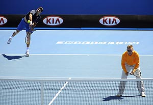 An umpire (right) plays as Mark Philippoussis' partner during a round one legends doubles match at the Australian Open tennis tournament in Melbourne, Sunday, Jan. 25, 2009. AAP Image/Julian Smith