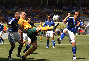 The Australian Socceroos' Mark Viduka kicks the ball in the Australia v Japan match. AAP Image/Dave Hunt