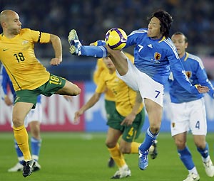 Australis's Mark Bresciano, left, fights for the ball with Japan's Yasuhito Endo, (7), during their soccer match for the World Cup Asia final qualifying in Yokohama, near Tokyo, Japan, Wednesday, Feb. 11, 2009. Game ended 0-0 draw. AP Photo/Shizuo Kambayashi