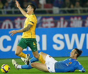 Australia's Tim Cahill, left, fights for the ball with Japan's Marcus Tulio Tanaka during their soccer match for the World Cup Asia final qualifying in Yokohama, near Tokyo, Japan, Wednesday, Feb. 11, 2009. (AP Ph,oto/Shizuo Kambayashi)
