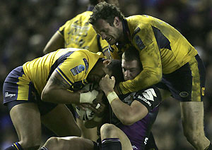 Leeds Rhinos Jamie Peacock, right, and Ryan Bailey, left, tackle Melbourne Storm's Anthony Quinn during their World Club Challenge Rugby League match at Elland Road Stadium, Leeds, England, Friday Feb. 29, 2008. AP Photo/Paul Thomas
