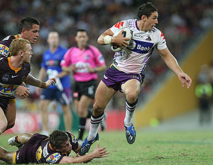 Storm player Billy Slater skips away from Andrew McCullough. AAP Image/Action Photographics, Colin Whelan