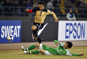 In this photo released by the Xinhua news agency, Petrovski Sasho of Australia's Newcastle Jets leaps over a player of China's Beijing Guo'an during the AFC Champions League group E round soccer match in Beijing on Tuesday on March 10, 2009. Beijing Guo'an won 2-0. AP Photo/Xinhua, Zhang Duo