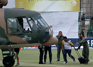 A Sri Lankan player boards into a helicopter at Gaddafi stadium after the shooting incident in Lahore, Pakistan on Tuesday, March, 3, 2009. A dozen men attacked Sri Lanka's cricket team with rifles, grenades and rocket launchers ahead of a match in Pakistan, wounding several players and killing six police officers and civilian in a brazen attack on South Asia's most beloved sport. (AP Photo/K.M. Chaudary)