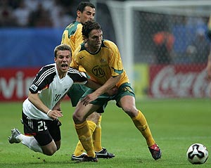 Germany's Lukas Podolski, left, and Australia's Ljubo Milicevic, right, challenge for the ball during the Confederations Cup match between Germany and Australia at the FIFA World Cup stadium in Frankfurt, western Germany, Wednesday, June 15, 2005. AP Photo/Michael Probst
